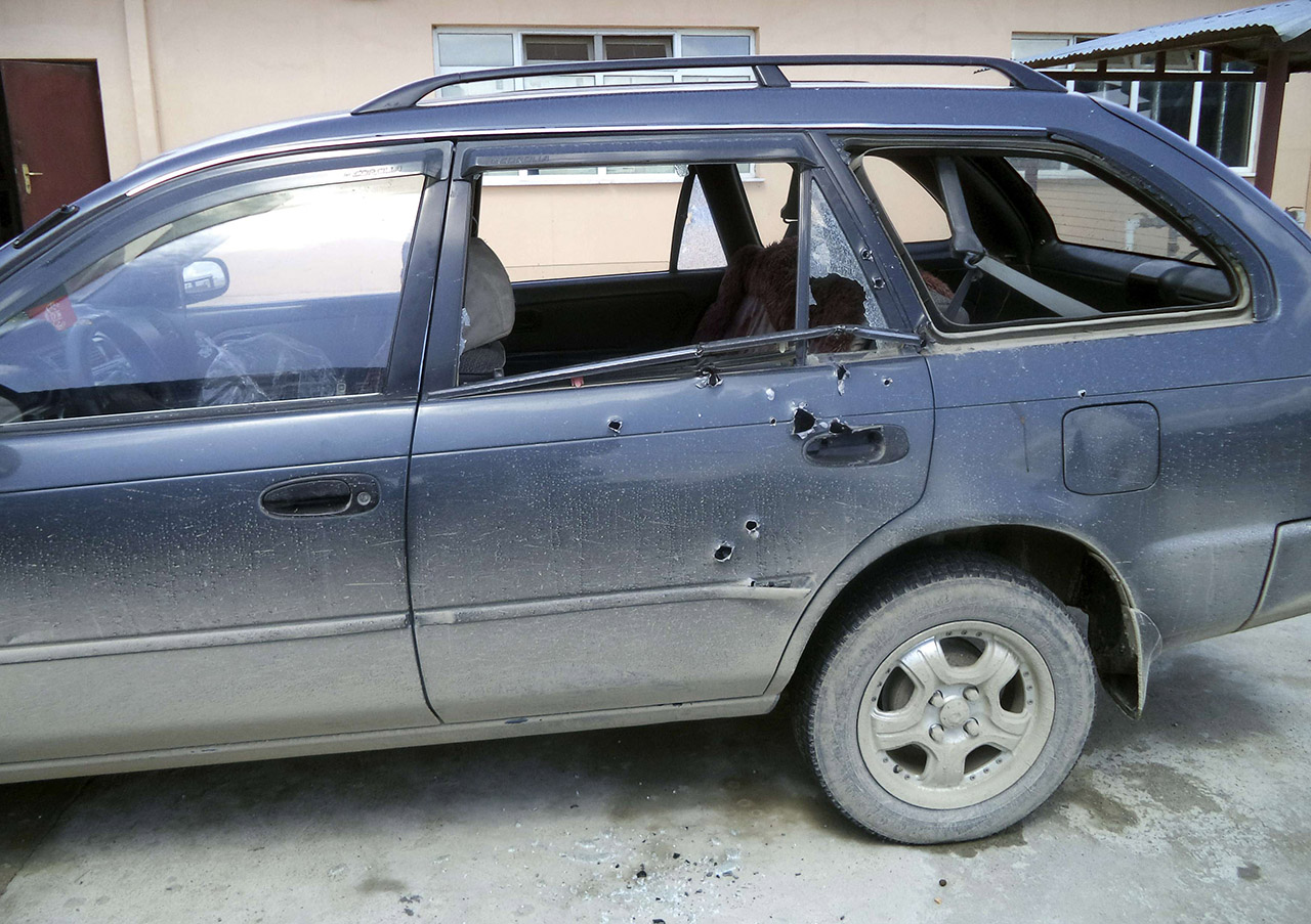 Bullet holes are seen in the car in which two foreign journalists were travelling when they were shot at, in Khost province