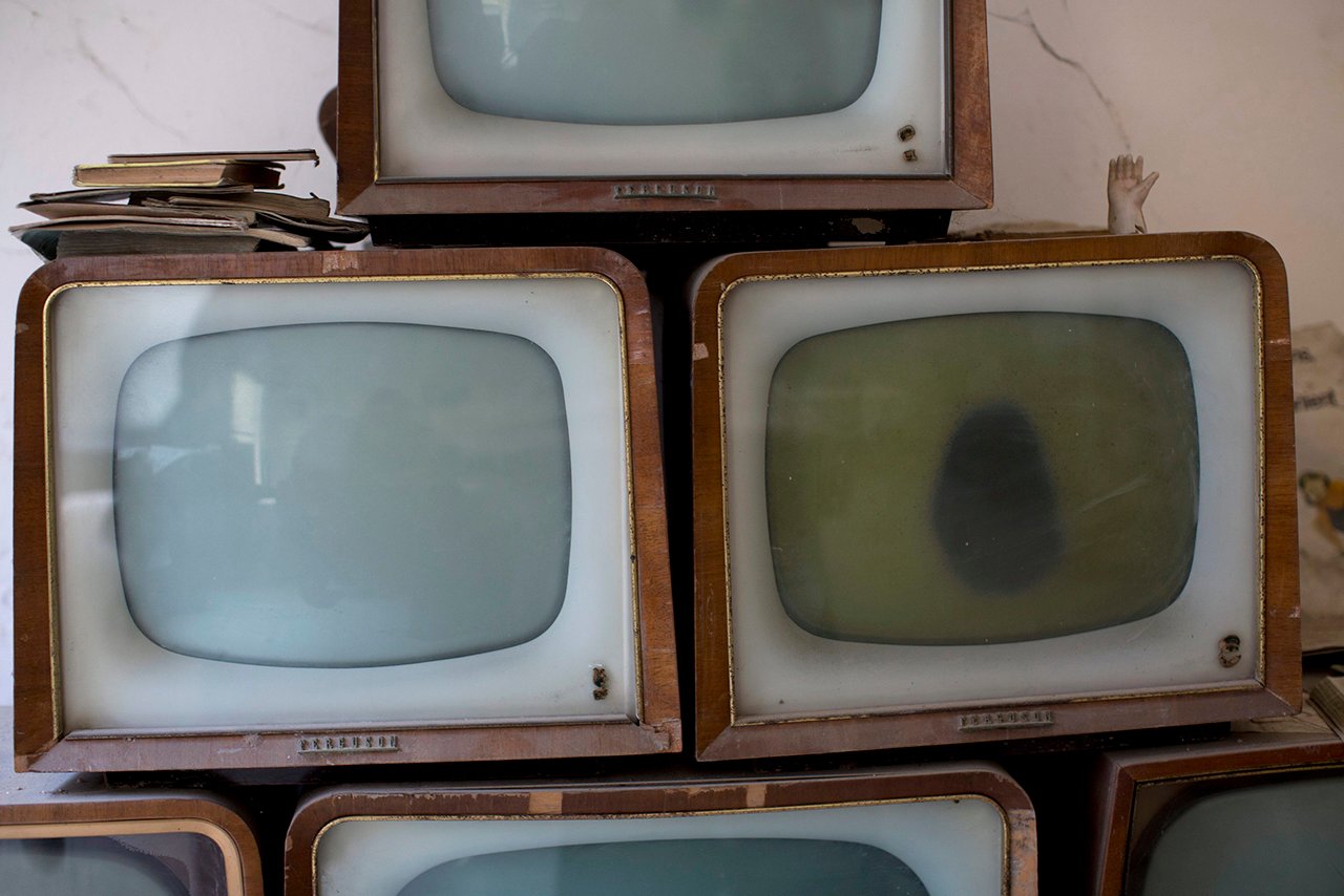 Old televisions found and collected by soldiers are seen in an abandoned commercial area in the United Nations buffer zone in central Nicosia