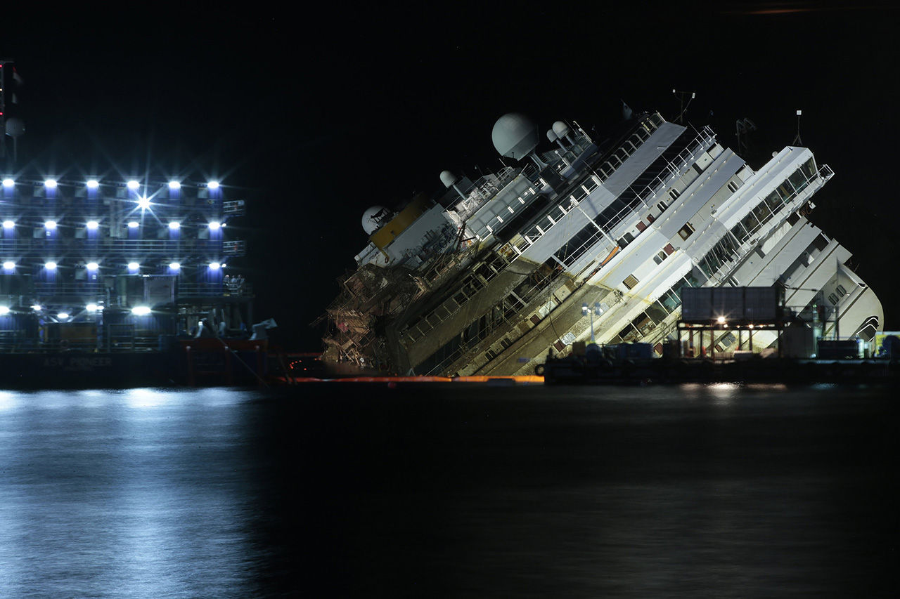 The capsized cruise liner Costa Concordia lies on its side during the 