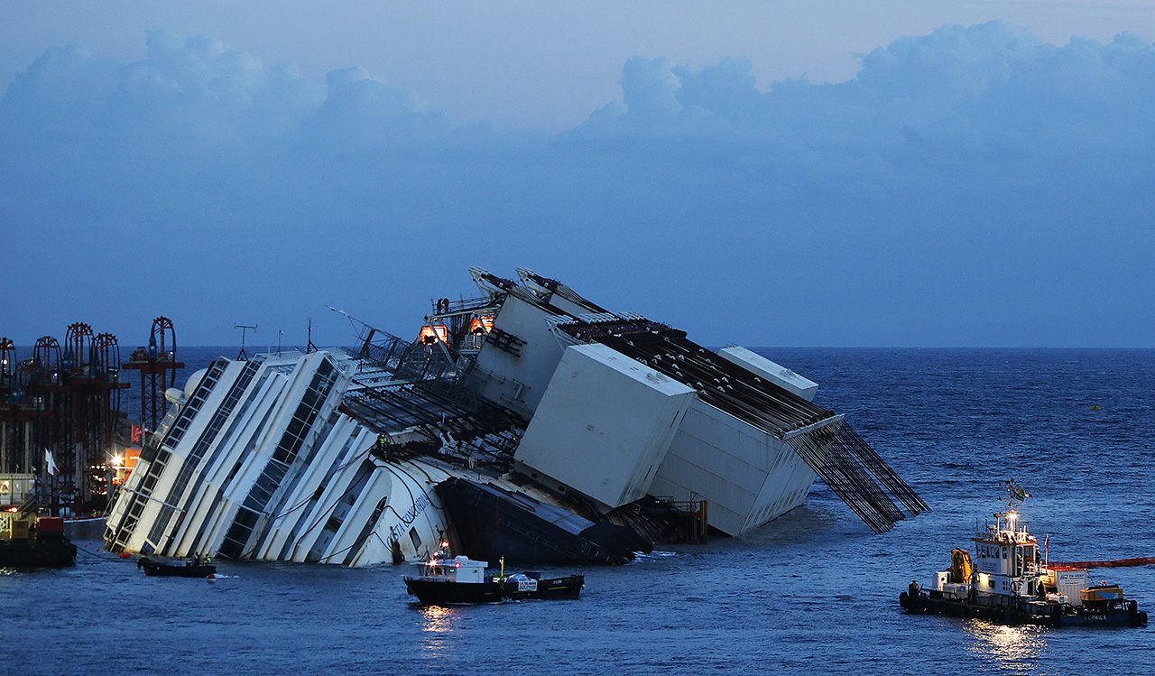 The capsized cruise liner Costa Concordia lies on its side next to Giglio Island