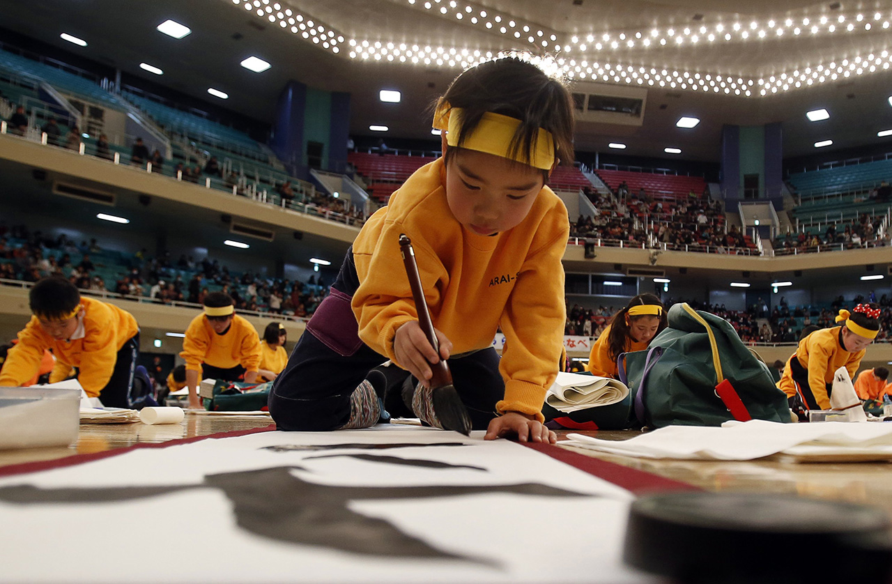 A boy participates in a new year calligraphy contest in Tokyo