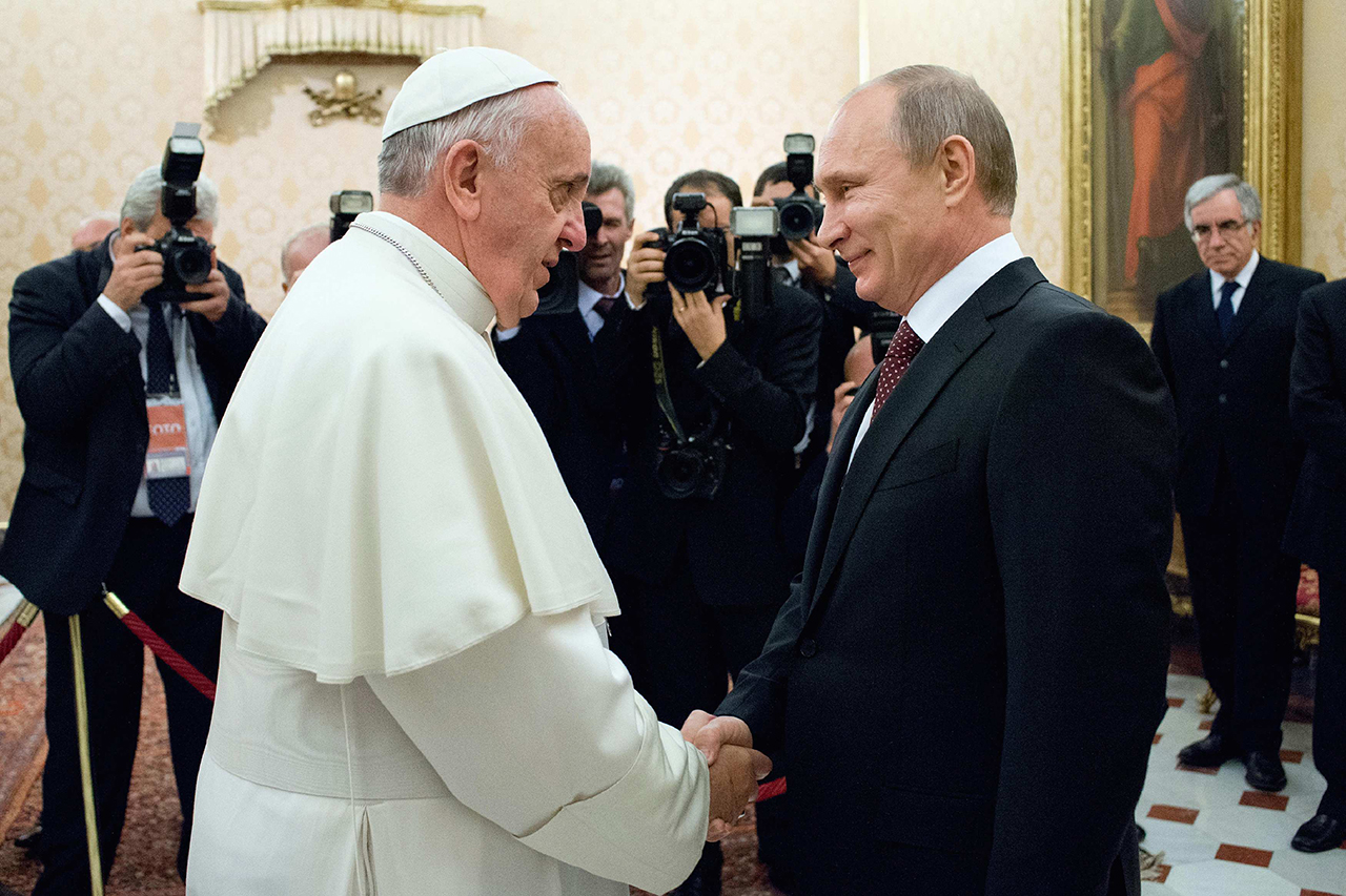 Pope Francis shakes hands with Russia's President Vladimir Putin during a private audience at the Vatican