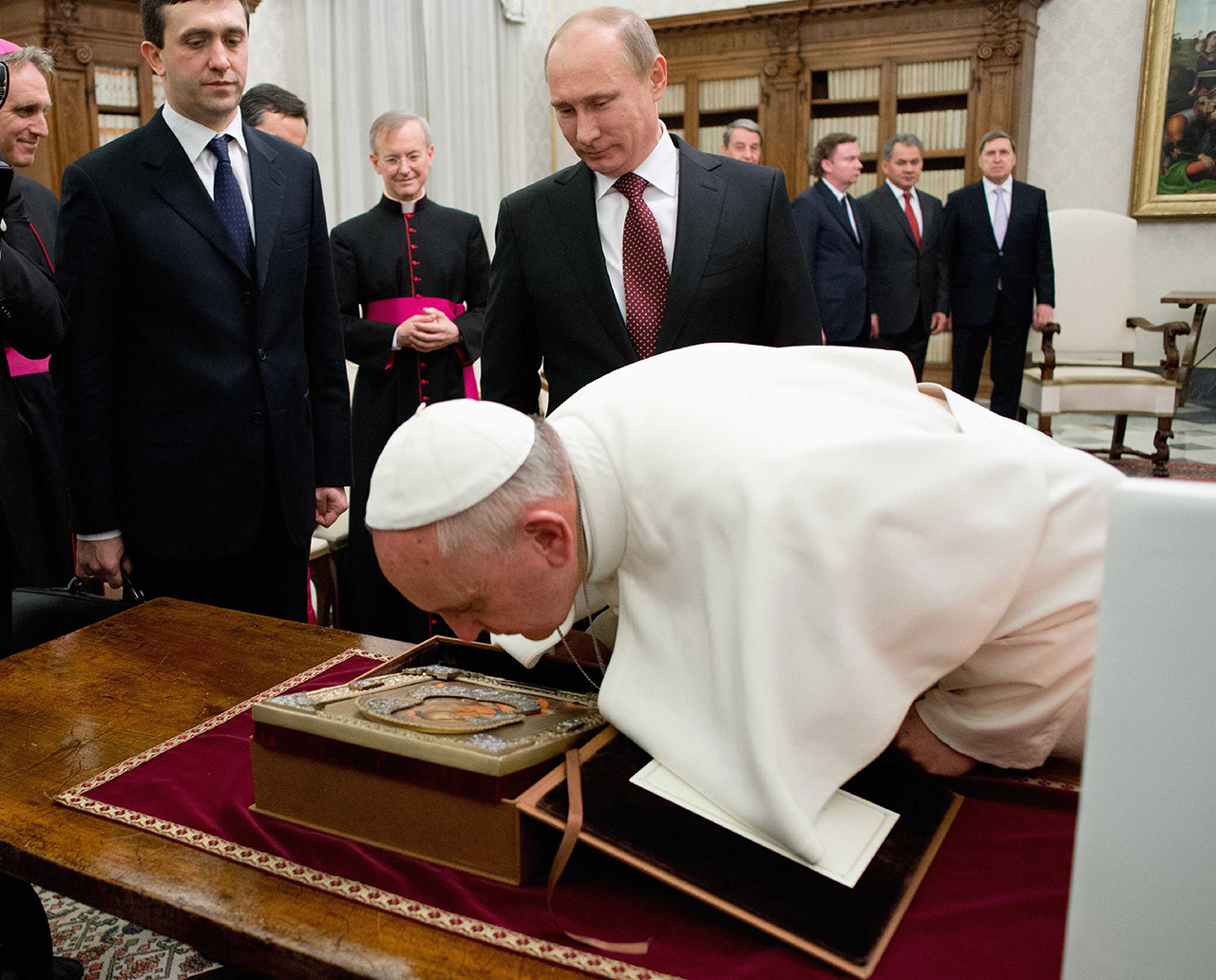 Pope Francis exchangse gifts with Russia's President Vladimir Putin during a private audience at the Vatican